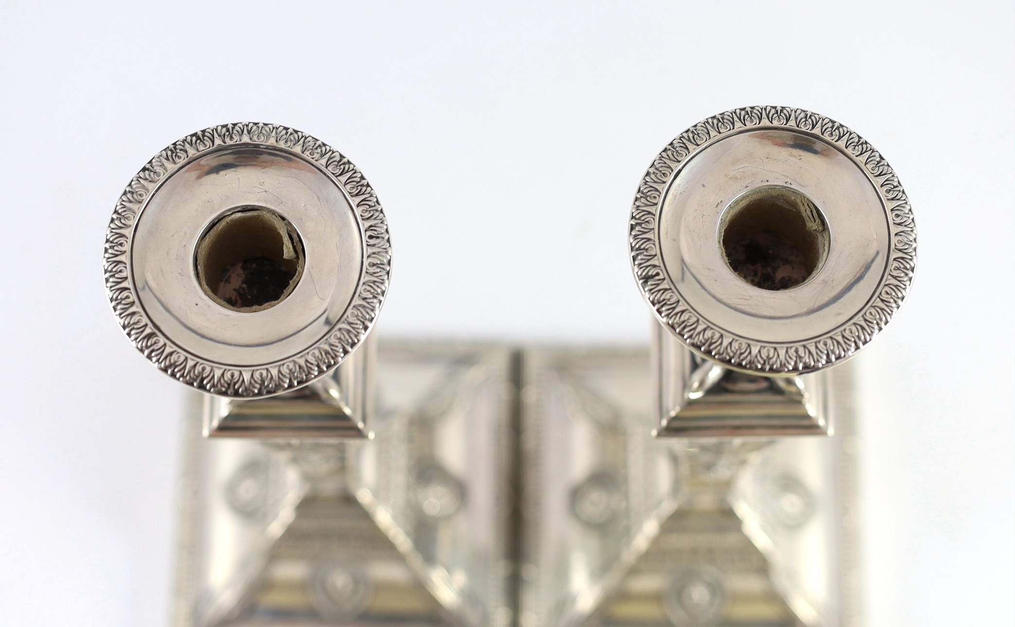 An ornate pair of late Victorian silver candlesticks by Mappin Bros.